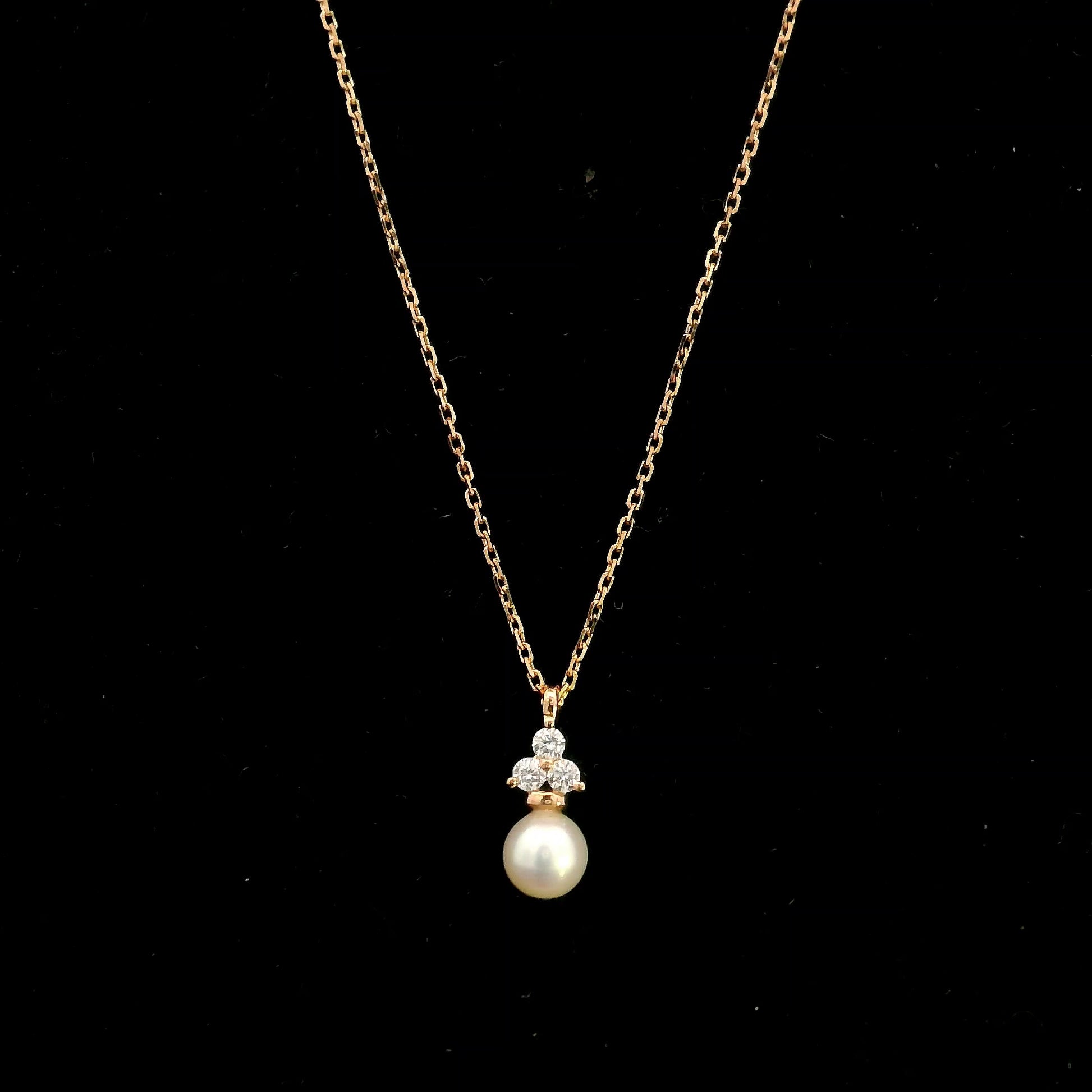18K rose gold freshwater pearl pendant necklace featuring a white freshwater pearl suspended beneath a natural diamond cluster.