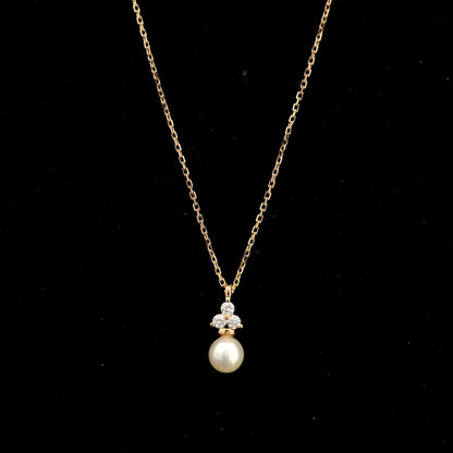 18K rose gold freshwater pearl pendant necklace featuring a white freshwater pearl suspended beneath a natural diamond cluster.