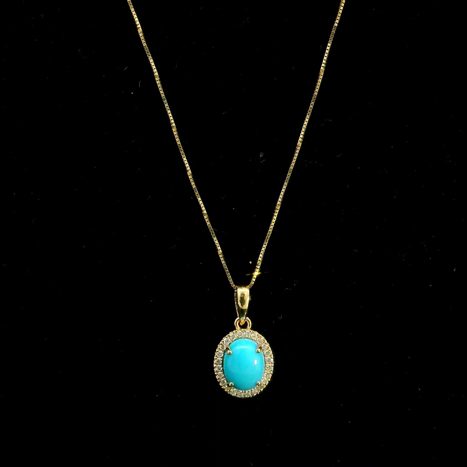 Natural turquoise diamond halo pendant in solid 18K yellow gold featuring a 1.22 carat oval turquoise surrounded by 0.12 carat natural diamonds.