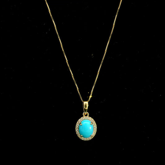 Natural turquoise diamond halo pendant in solid 18K yellow gold featuring a 1.22 carat oval turquoise surrounded by 0.12 carat natural diamonds.