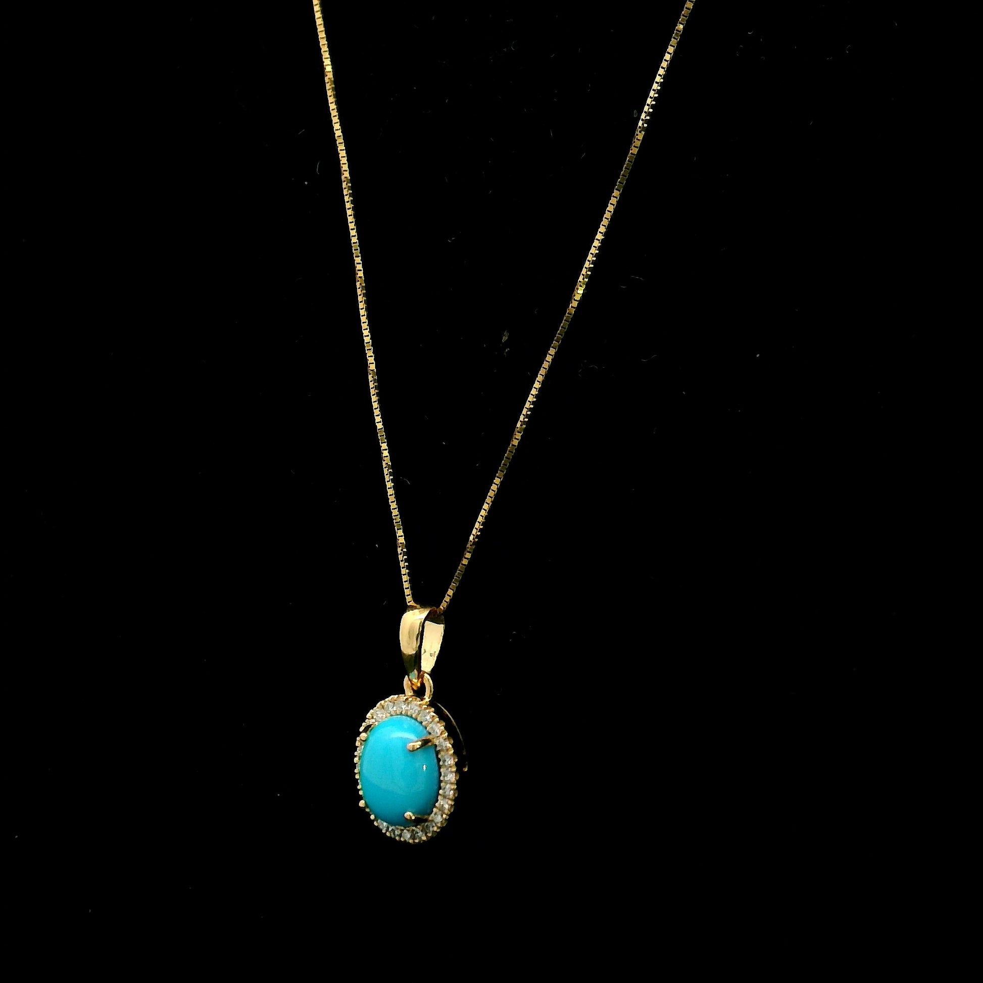 Natural turquoise diamond halo pendant in solid 18K yellow gold featuring a 1.22 carat oval turquoise surrounded by 0.12 carat natural diamonds.