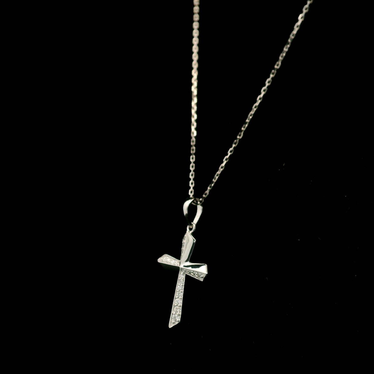 18K white gold diamond cross pendant featuring 0.23 carat natural round brilliant diamonds in a modern geometric cross design.