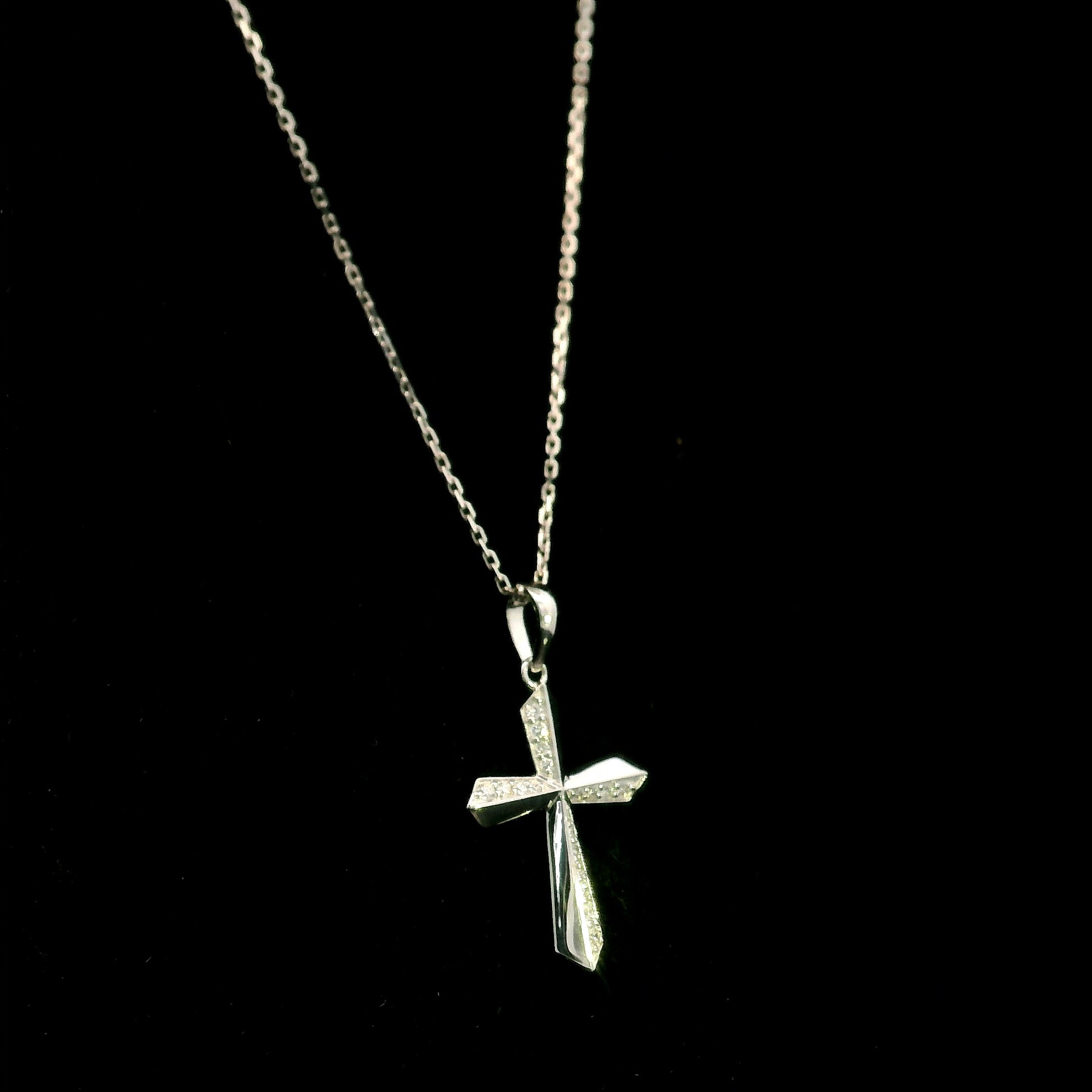 18K white gold diamond cross pendant featuring 0.23 carat natural round brilliant diamonds in a modern geometric cross design.