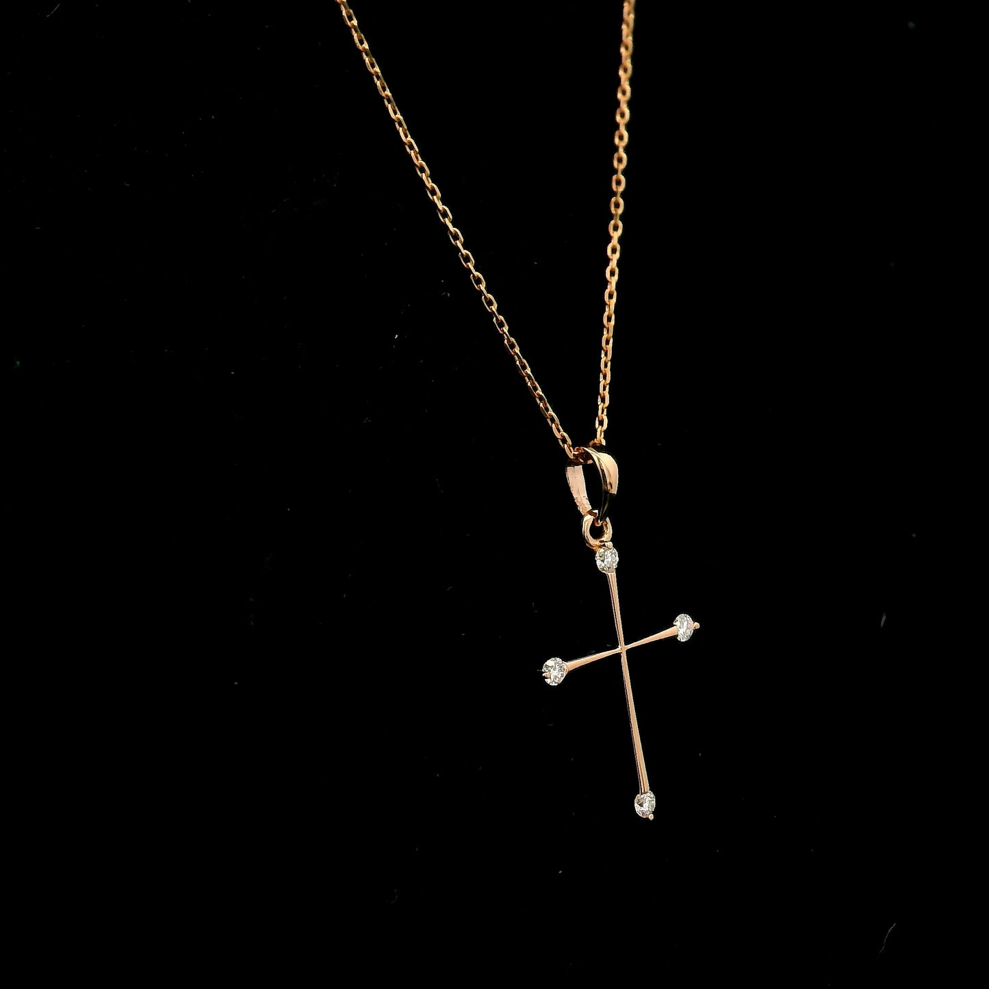 18K rose gold minimalist natural diamond cross pendant with four round brilliant diamonds.