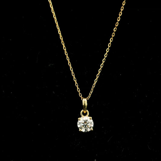 18K yellow gold solitaire pendant featuring a 0.70 carat GIA certified round brilliant natural diamond in a classic four-prong setting, supplied without a chain.