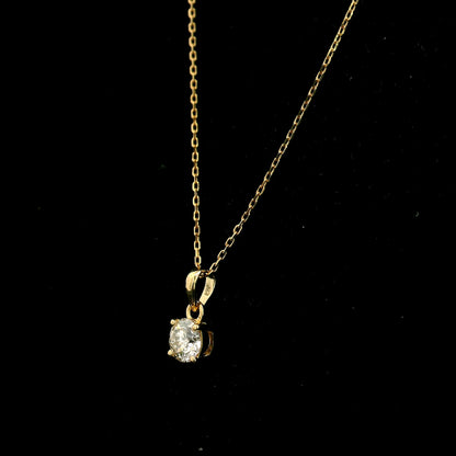 18K yellow gold solitaire pendant featuring a 0.70 carat GIA certified round brilliant natural diamond in a classic four-prong setting, supplied without a chain.