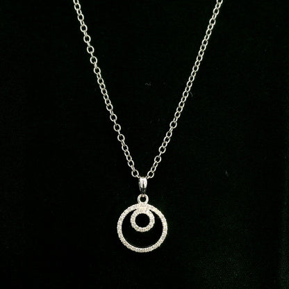 Diamond circle pendant with interlocking open-circle design in 18K white gold, set with round brilliant diamonds.