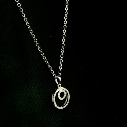 Diamond circle pendant with interlocking open-circle design in 18K white gold, set with round brilliant diamonds.