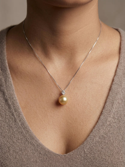 South Sea golden pearl and diamond pendant in 18K white gold featuring a 10 x 13 mm golden pearl and pear-shaped diamond detail.