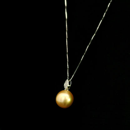 South Sea golden pearl and diamond pendant in 18K white gold featuring a 10 x 13 mm golden pearl and pear-shaped diamond detail.