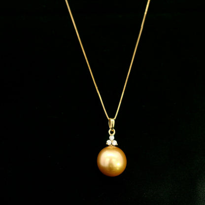 South Sea Golden Pearl and diamond pendant in 18K yellow gold featuring a 10 x 13 mm golden pearl and round diamond accents