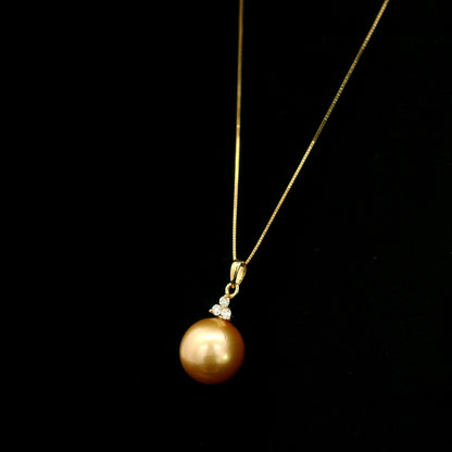 South Sea Golden Pearl and diamond pendant in 18K yellow gold featuring a 10 x 13 mm golden pearl and round diamond accents