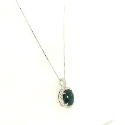 Oval sapphire and diamond halo pendant in 18K white gold with diamond-set bail