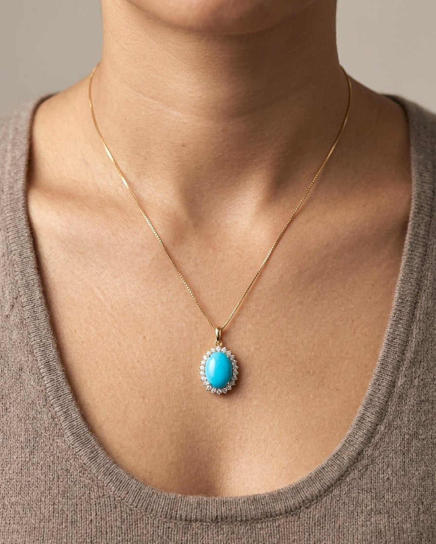 Oval turquoise and diamond halo pendant in 18K yellow gold with 3.81 carat turquoise and round diamonds