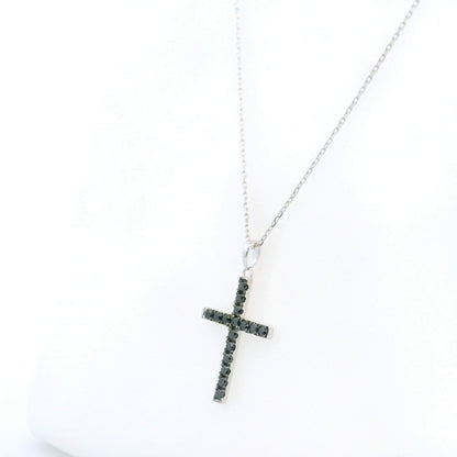 Black diamond cross pendant in 18K white gold set with round black diamonds in a slender cross design.