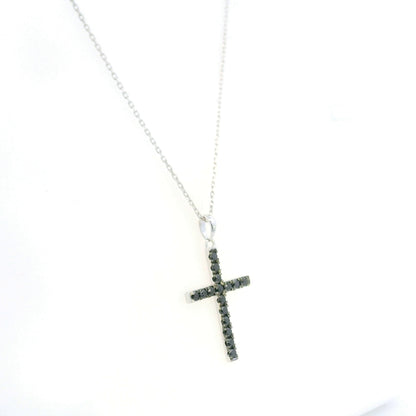 Black diamond cross pendant in 18K white gold set with round black diamonds in a slender cross design.