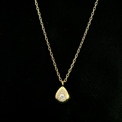 Diamond teardrop pendant necklace in 18K yellow gold featuring round brilliant diamonds arranged within a pear-shaped gold frame.