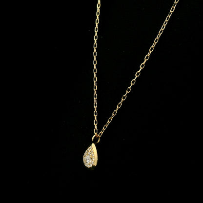 Diamond teardrop pendant necklace in 18K yellow gold featuring round brilliant diamonds arranged within a pear-shaped gold frame.