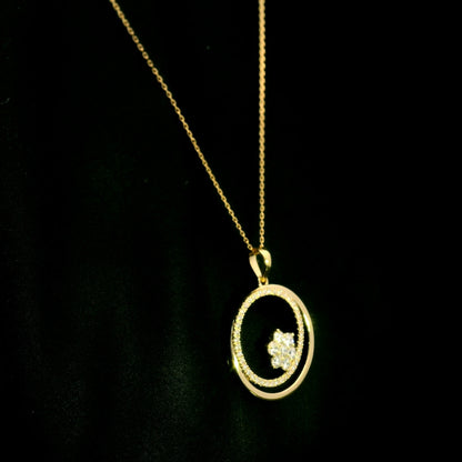 Diamond circle pendant in 18K yellow gold featuring an open circular design with a floral-inspired round diamond cluster and diamond-set curve.