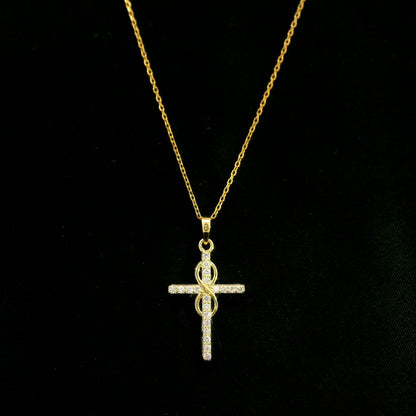 Diamond cross pendant in 18K yellow gold with round brilliant diamonds and an intertwined gold centre design