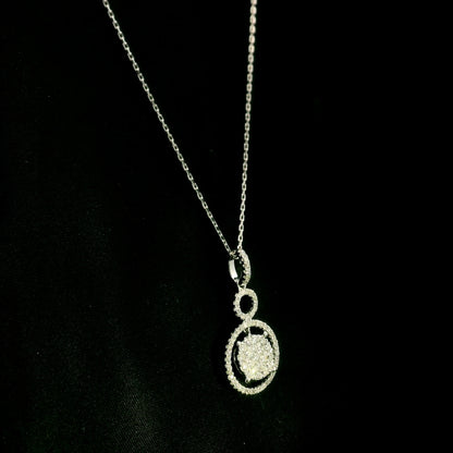 Diamond circle pendant in 18K white gold featuring a suspended diamond cluster with open circular diamond details.
