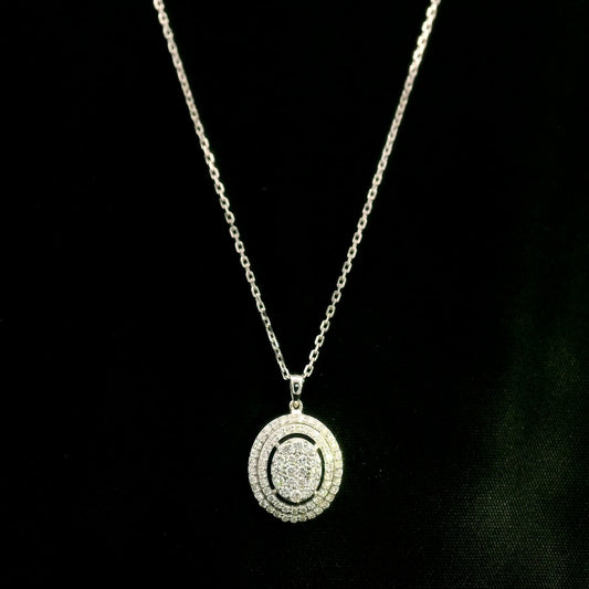 Oval diamond cluster pendant in 18K white gold with a central round diamond cluster and two diamond-set oval surrounds.