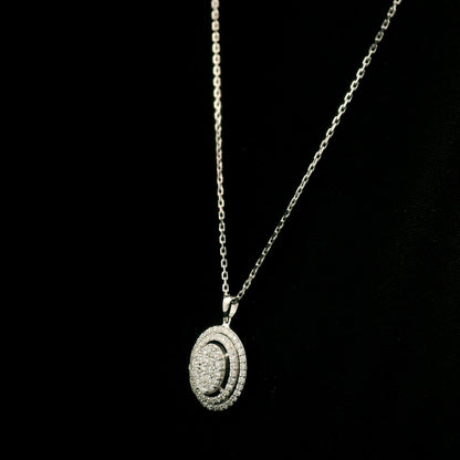Oval diamond cluster pendant in 18K white gold with a central round diamond cluster and two diamond-set oval surrounds.