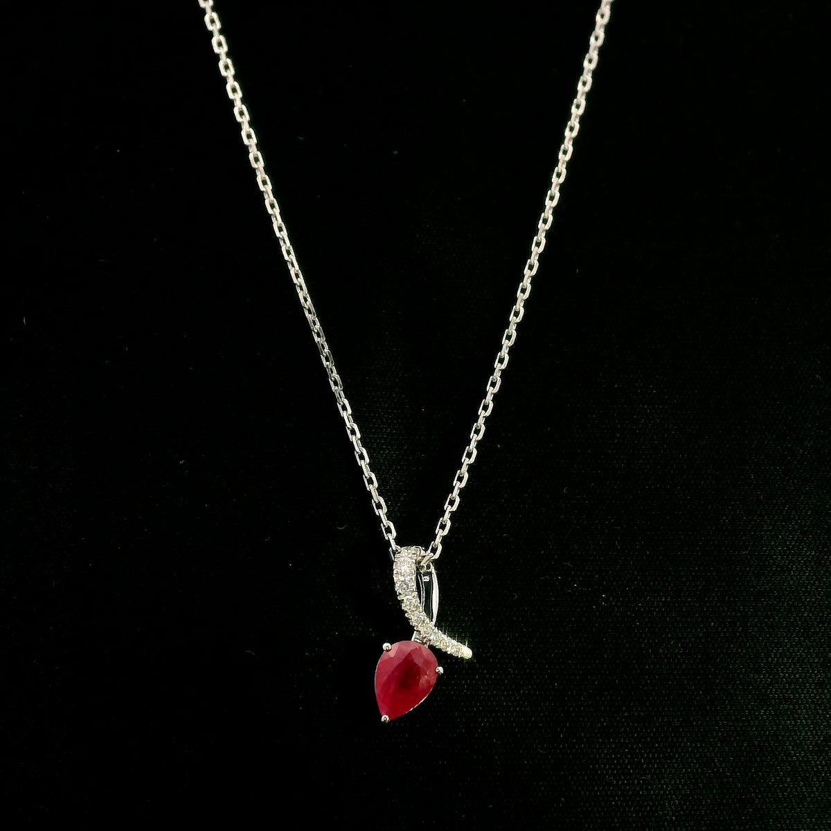 Pear shaped ruby and diamond pendant in 18K white gold
