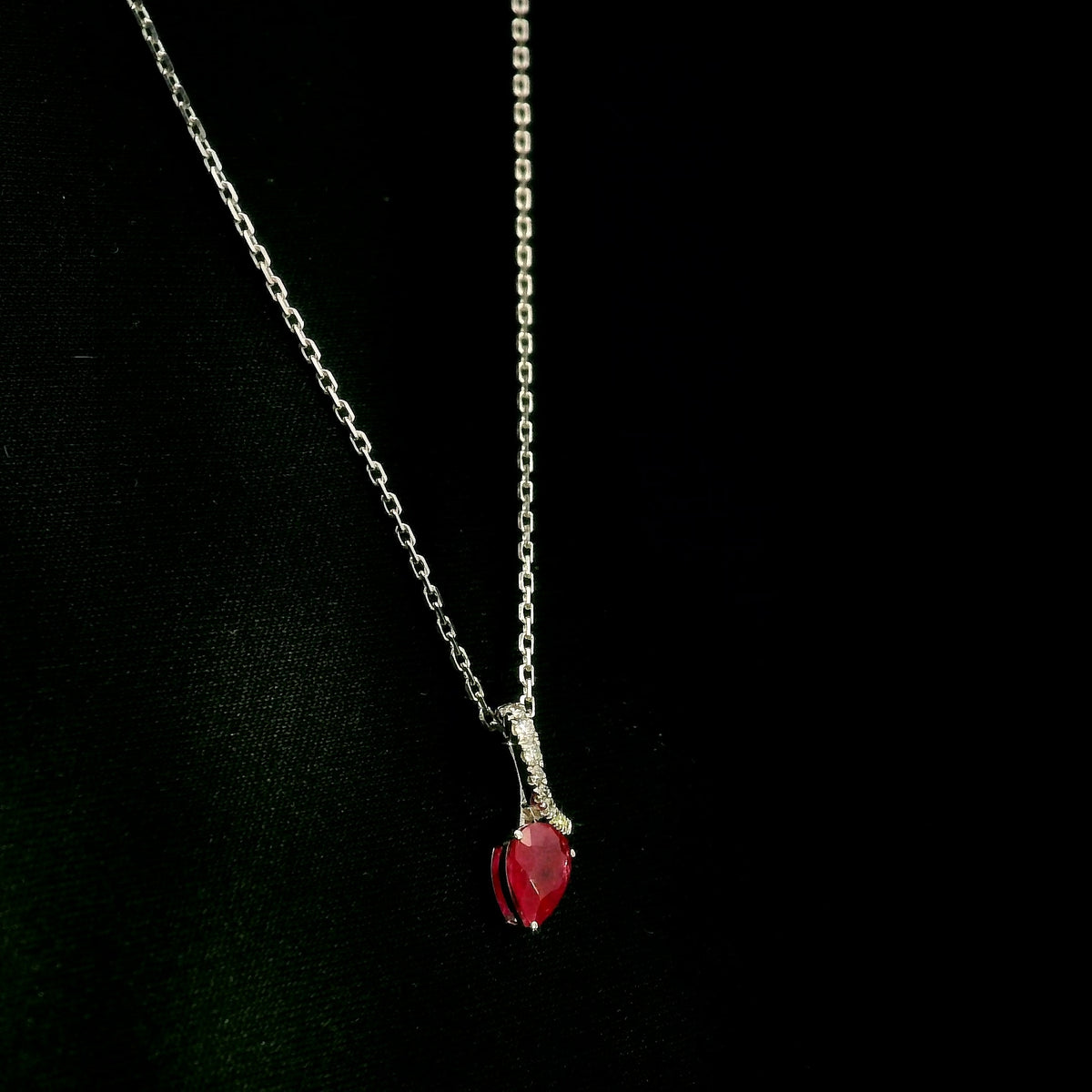 Pear shaped ruby and diamond pendant in 18K white gold