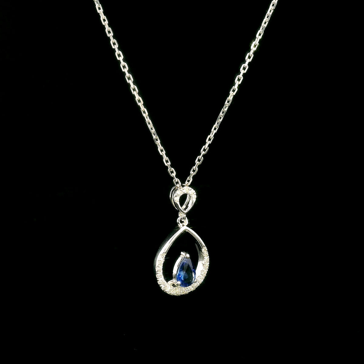 Pear shaped blue sapphire and diamond teardrop pendant in 18K white gold without chain