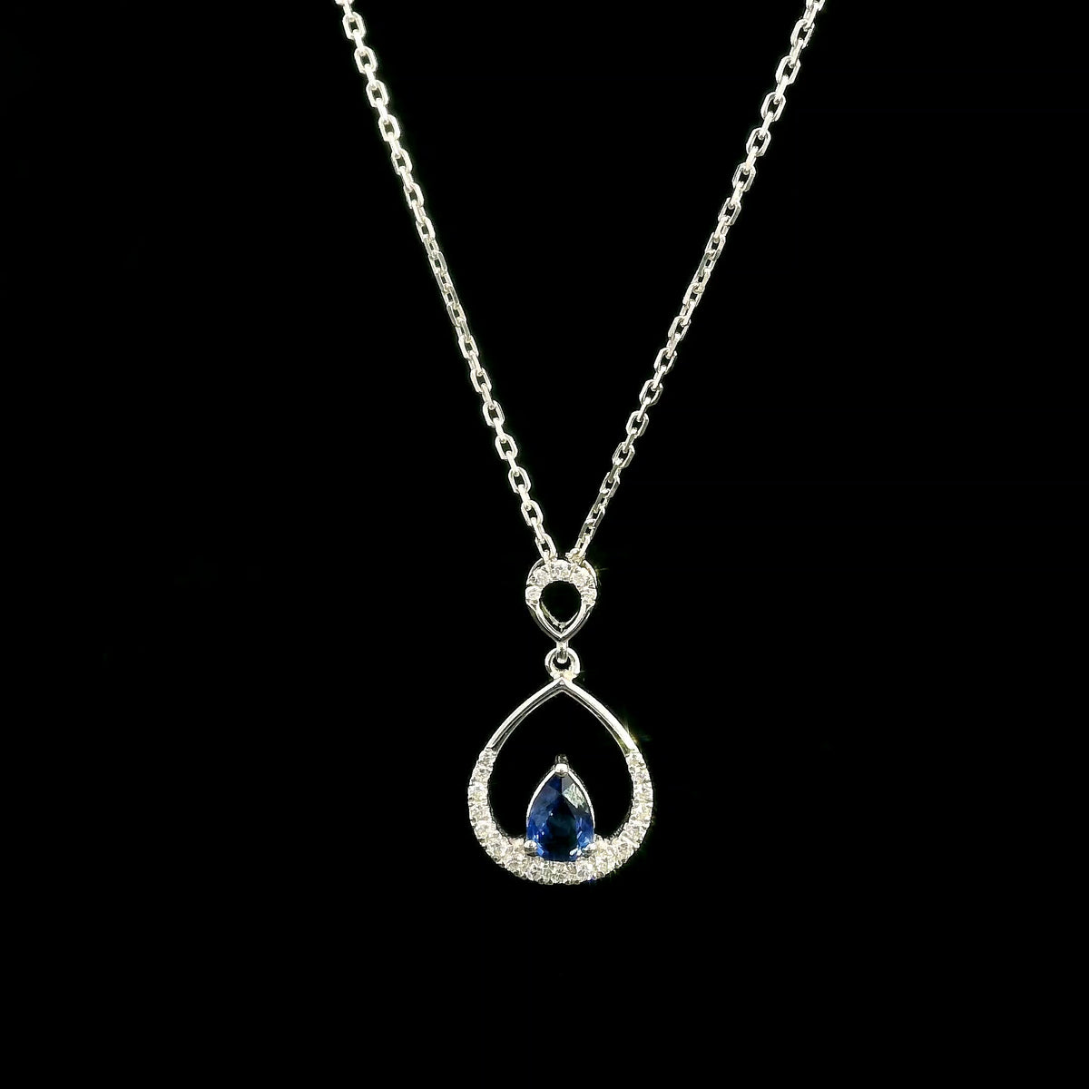 Pear shaped blue sapphire and diamond teardrop pendant in 18K white gold without chain