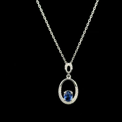 Oval blue sapphire and diamond pendant in 18K white gold with open oval design