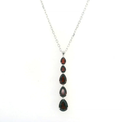 Pear shaped garnet drop pendant in 18K white gold featuring five graduated deep red garnets totalling 2.26 carat, arranged vertically in delicate prong settings. Chain  sold separately 