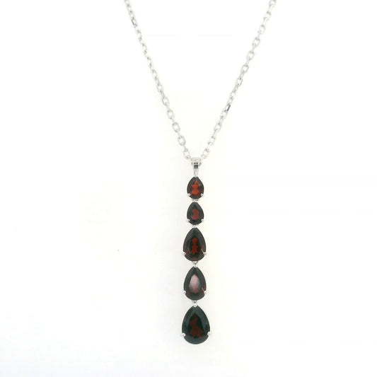 Pear shaped garnet drop pendant in 18K white gold featuring five graduated deep red garnets totalling 2.26 carat, arranged vertically in delicate prong settings. Chain  sold separately 
