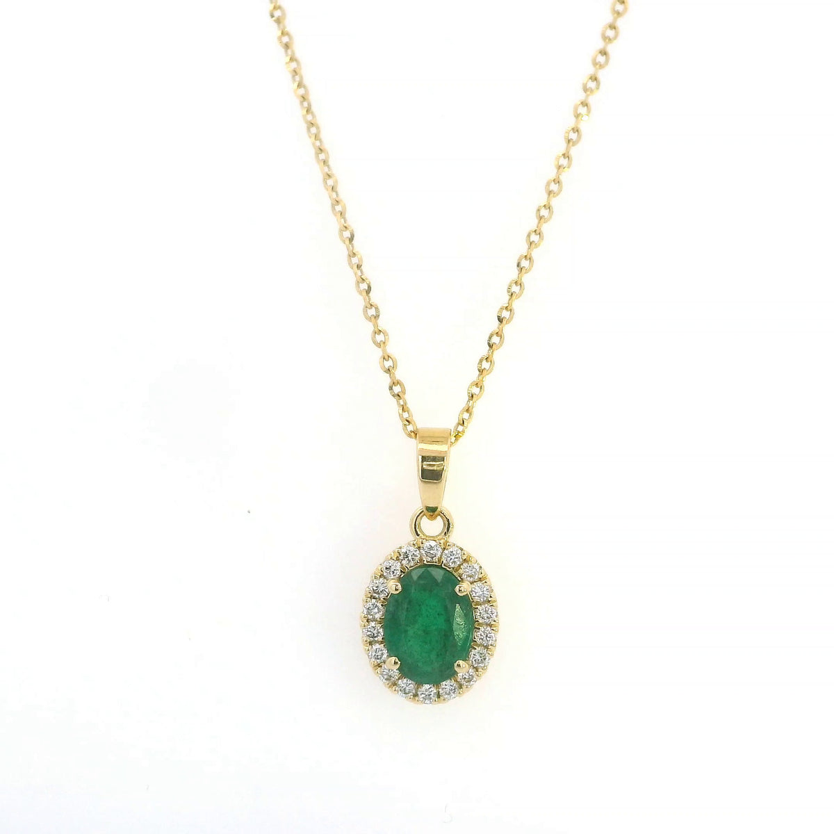 Oval emerald and diamond halo pendant in 18K yellow gold featuring a 1.30 carat green emerald surrounded by round diamonds totalling 0.23 carat. 