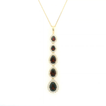 18K yellow gold garnet and diamond drop pendant featuring five pear shaped red garnets totalling 2.26 carats, each surrounded by a halo of round diamonds totalling 0.36 carat. Chain not included.
