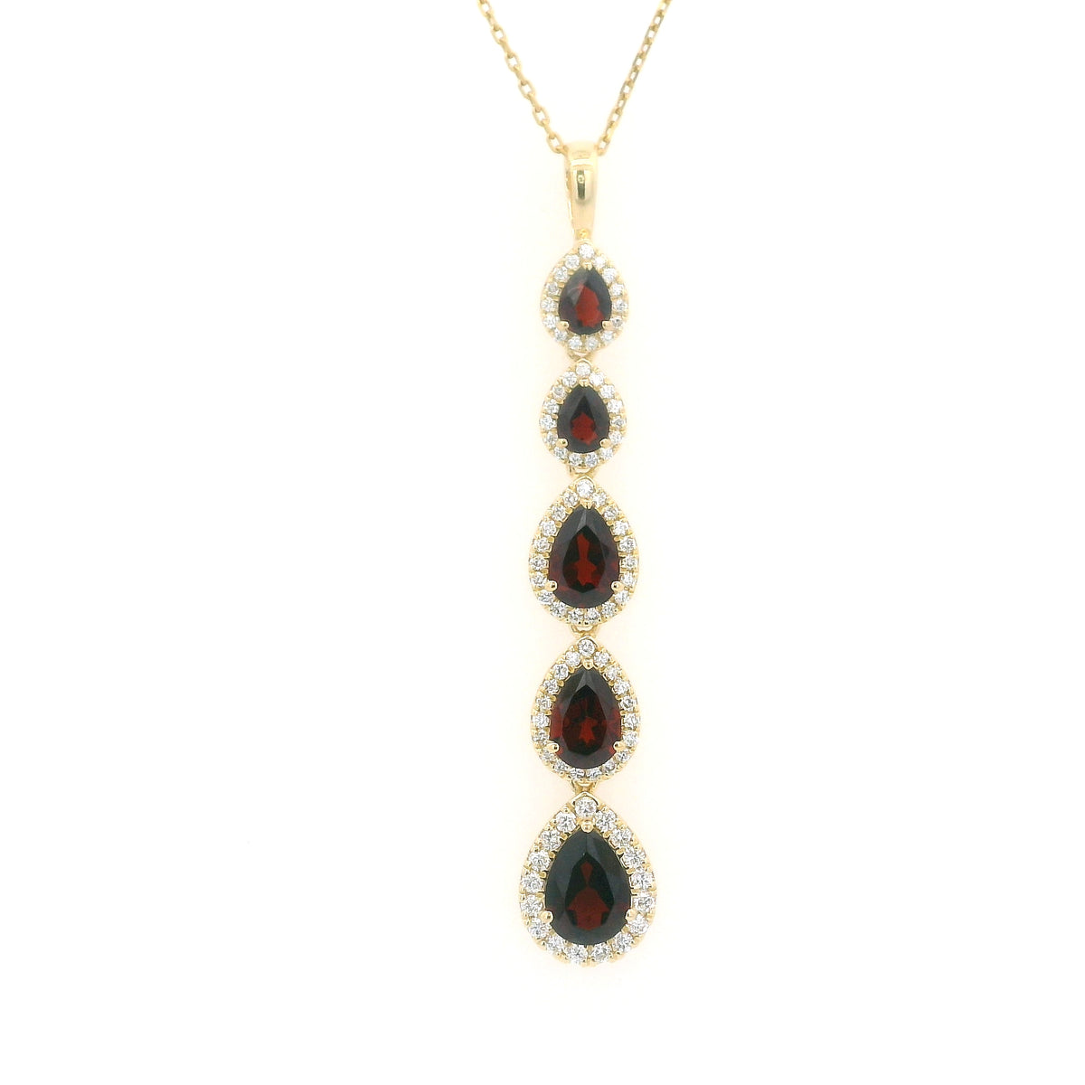 18K yellow gold garnet and diamond drop pendant featuring five pear shaped red garnets totalling 2.26 carats, each surrounded by a halo of round diamonds totalling 0.36 carat. Chain not included.