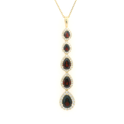 18K yellow gold garnet and diamond drop pendant featuring five pear shaped red garnets totalling 2.26 carats, each surrounded by a halo of round diamonds totalling 0.36 carat. Chain not included.