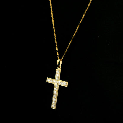 18K yellow gold Christian cross pendant with round diamonds set along the vertical and horizontal arms, shown hanging from a fine gold chain.