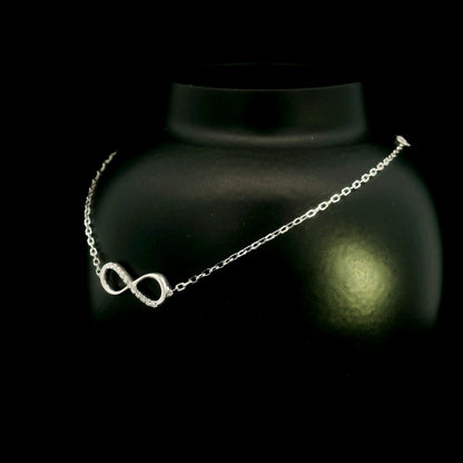 Diamond infinity bracelet in 18K White Gold featuring a pavé-set infinity motif with 0.05 carat natural diamonds.