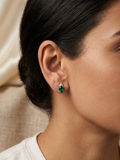 Emerald and diamond drop earrings in 18K yellow gold featuring 0.78 carat emeralds and 0.07 carat diamonds by Emirates Diamonds.