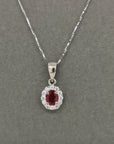 Ruby With Diamond Halo Pendant In 18k White Gold.