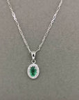Emerald With Diamond Halo Pendant In 18k White Gold.
