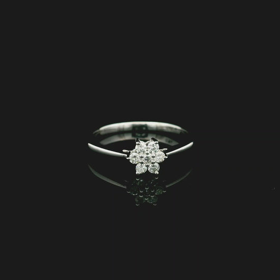 18K white gold floral diamond cluster ring with delicate minimalist design.
