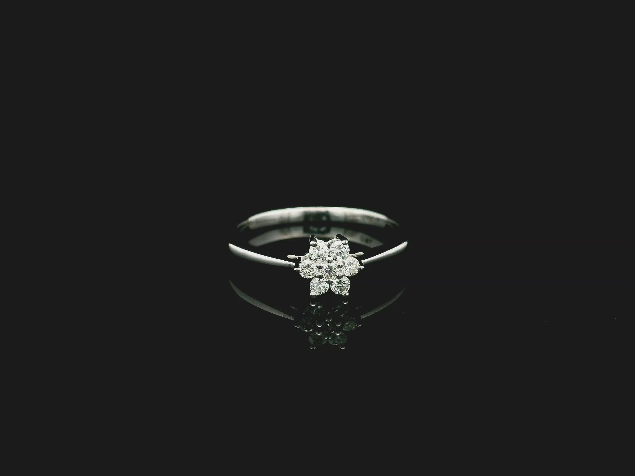 18K white gold floral diamond cluster ring with delicate minimalist design.