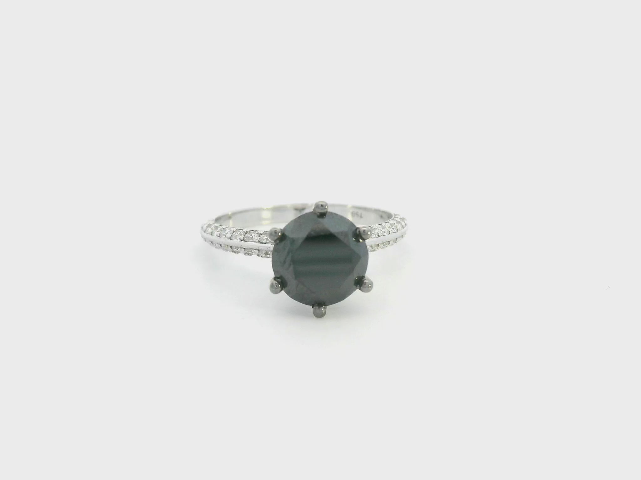 18K white gold black diamond solitaire ring with pavé diamond band by Emirates Diamonds.