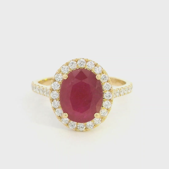 Oval ruby halo ring with diamonds in 18K yellow gold by Emirates Diamonds