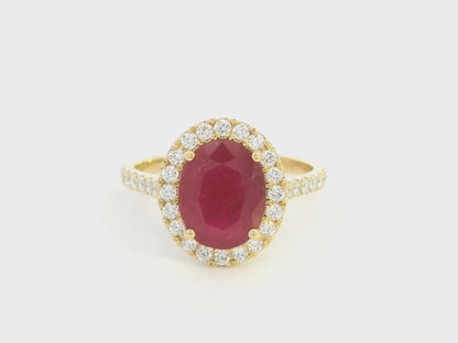 Oval ruby halo ring with diamonds in 18K yellow gold by Emirates Diamonds