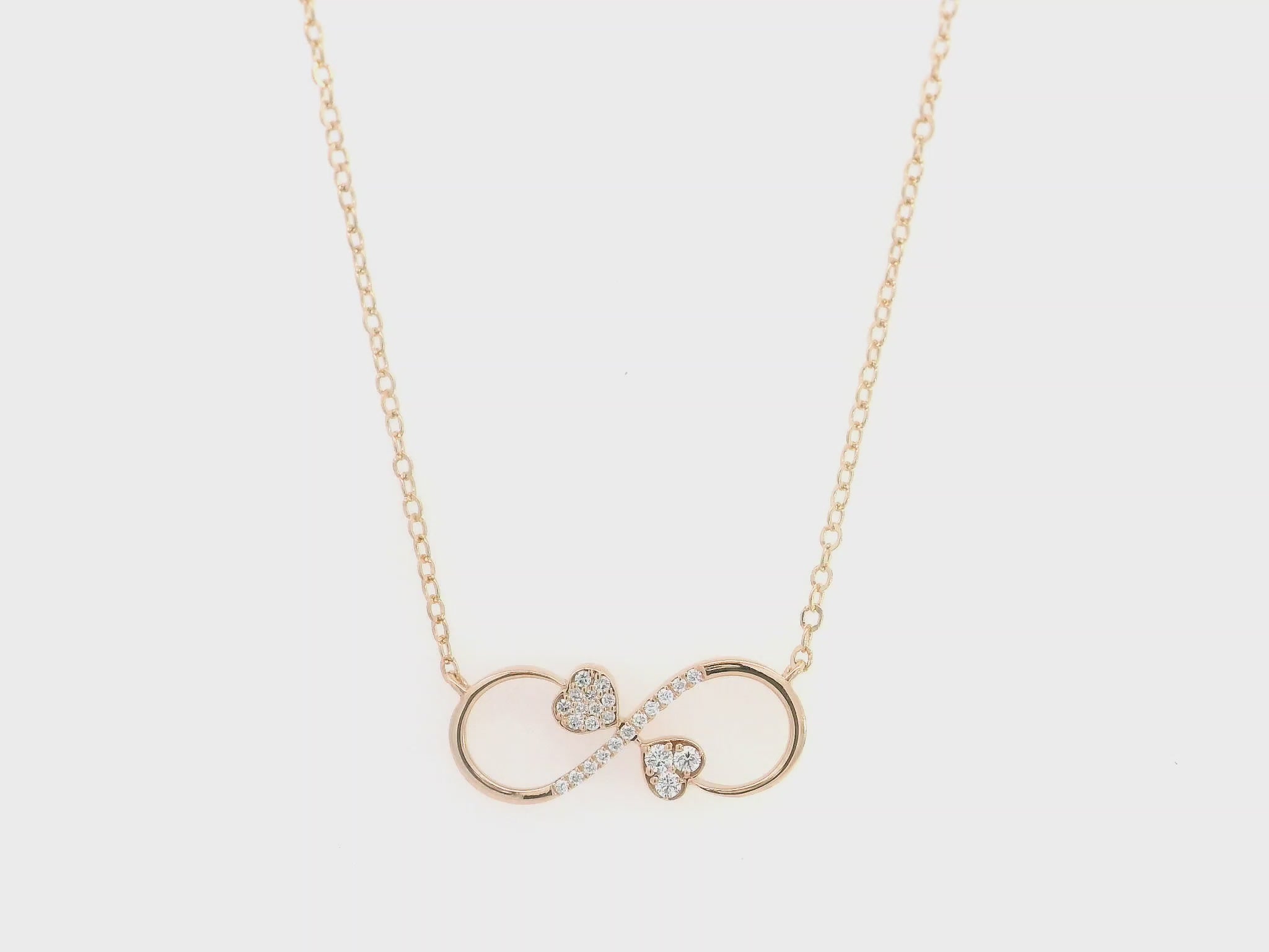 18K rose gold infinity heart necklace with pavé diamonds and double heart design.