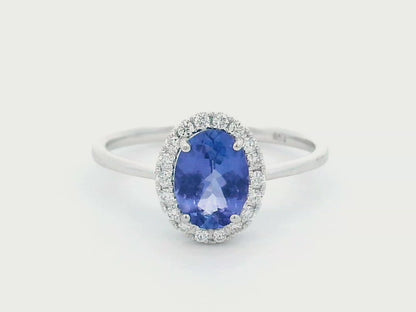 Ethereal Elegance: Oval-Cut Tanzanite and Diamond Halo Ring In 18k Gold.